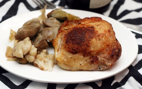 Crispy chicken thighs with cauliflower, artichoke and olives