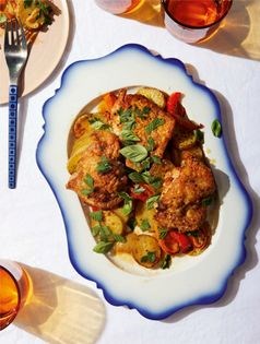 Crispy chicken thighs with schmaltzy potatoes, red pepper, and onion