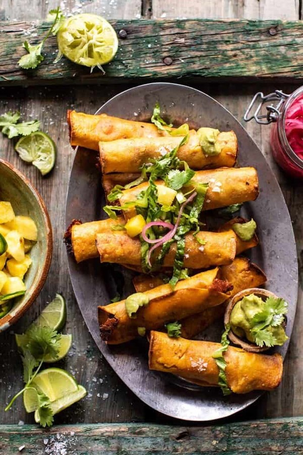 Crispy chicken tinga taquitos with lime avocado crema