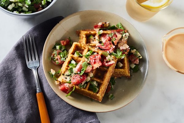 Crispy chickpea waffles with herby Israeli salad & harissa tahini sauce