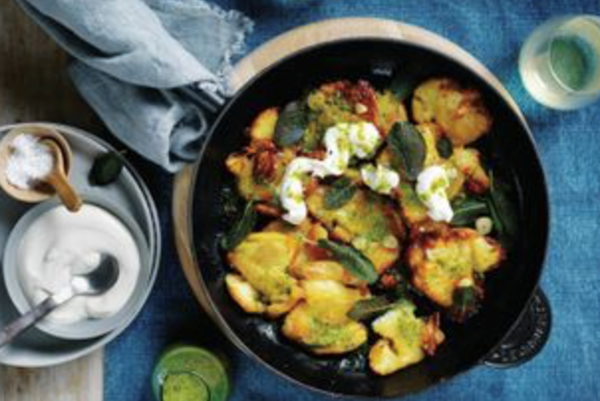 Crispy crushed potatoes with creme fraiche and herb oil