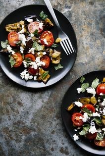 Crispy eggplant with fresh mozzarella, tomatoes, pickled raisins, and mint