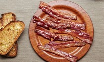 Crispy grilled bacon with creamed corn on sourdough