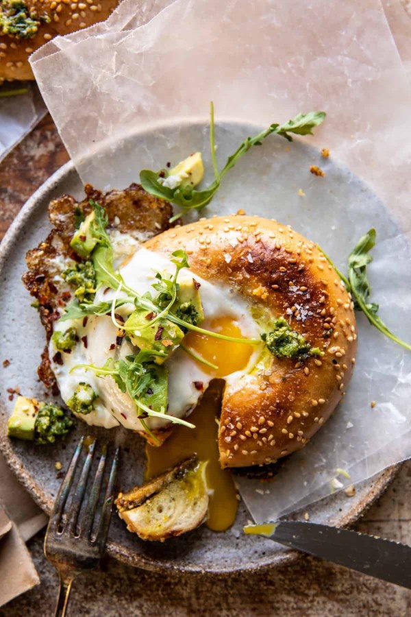 Crispy Parmesan and pesto egg in a bagel