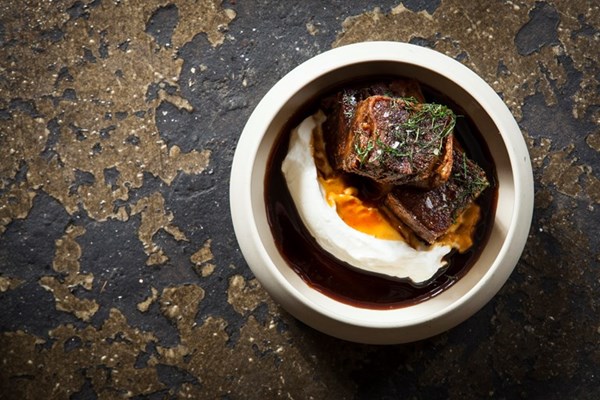 Crispy pomegranate-glazed lamb breast with yoghurt
