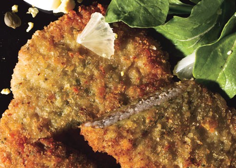 Crispy pork cutlets with capers, lemon, arugula, and chopped eggs