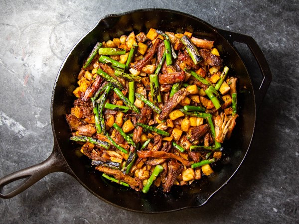 Crispy pork shoulder hash with charred asparagus and serrano chili