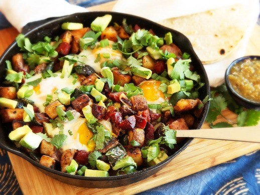 Crispy potato, chorizo, and green chili hash with avocado and eggs