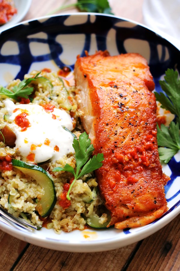 Crispy salmon with tahini yogurt sauce, freekeh, zucchini and dates