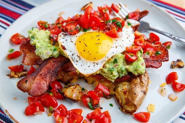 Crispy smashed potato pancakes with guacamole, pico de gallo, bacon and eggs