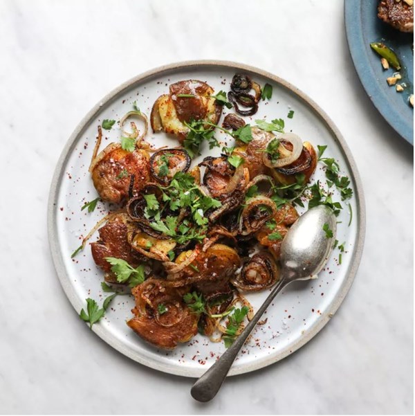 Crispy smashed potatoes with fried onions and parsley