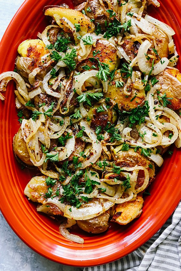 Crispy smashed potatoes with fried onion and parsley