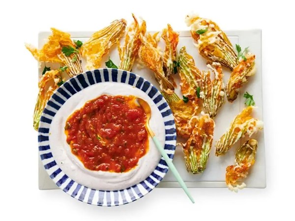 Crispy squash blossoms with tomato jam and whipped goat cheese [Ayesha Nurdjaja]