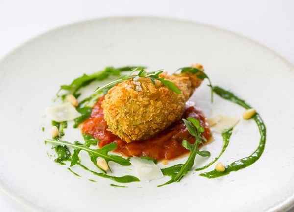 Crispy stuffed courgette flower with tomato fondue and basil sauce