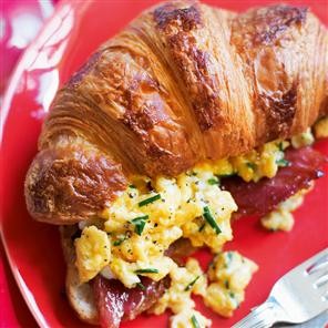 Croissants stuffed with glazed ham and creamy scrambled egg