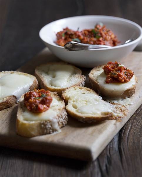 Crostini with Brie and sundried tomato-walnut tapenade