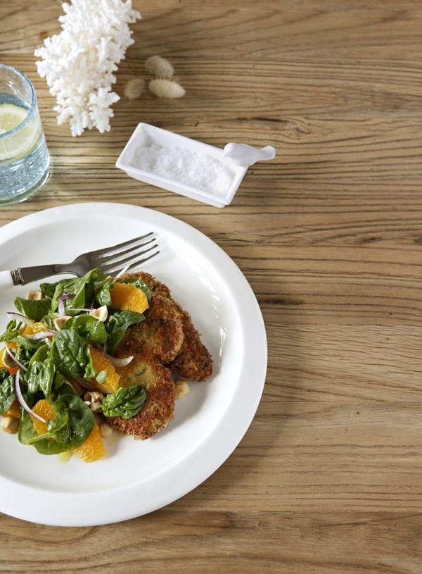 Crumbed pork schnitzel with spinach, orange and hazelnut salad