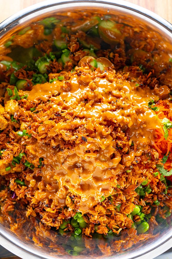 Crunchy chicken satay salad with crispy chili rice and peanut dressing