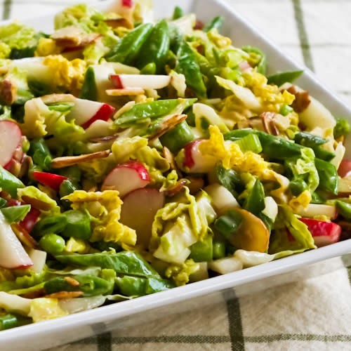 Crunchy napa cabbage Asian slaw with sugar snap peas, radishes, almonds and cilantro