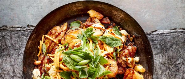 Crushed fried potatoes with curry powder salt, lime pickle yogurt and Bombay mix