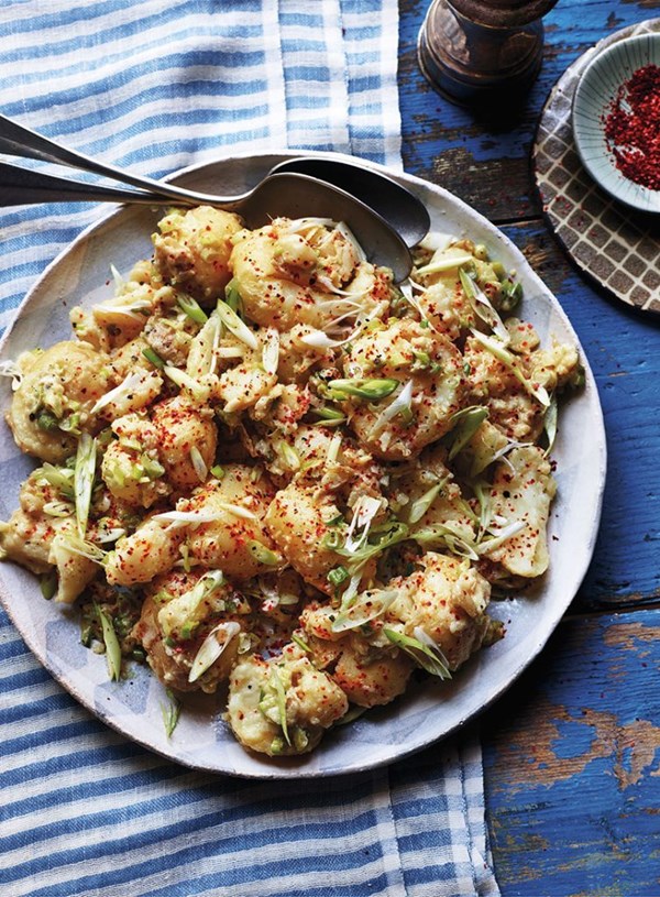 Crushed new potatoes with tahini butter and spring onions