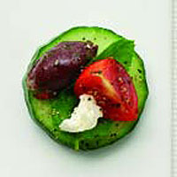 Cucumber rounds with feta, tomato, Kalamata olives and mint
