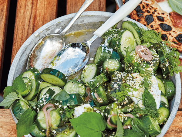 Cucumbers with herby yogurt dressing and sesame seeds