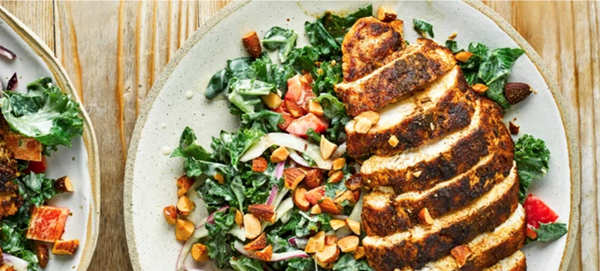 Cumin-crusted chicken with kale salad and hummus dressing