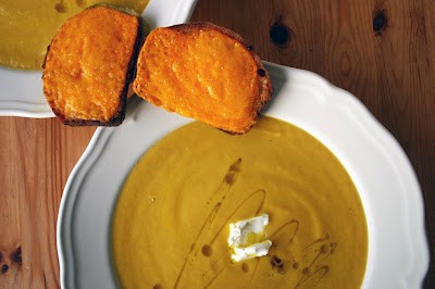 Curried fennel and carrot soup served with melted cheese on sourdough
