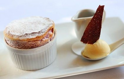Dark cherry soufflé with clotted cream ice cream and dark chocolate sauce