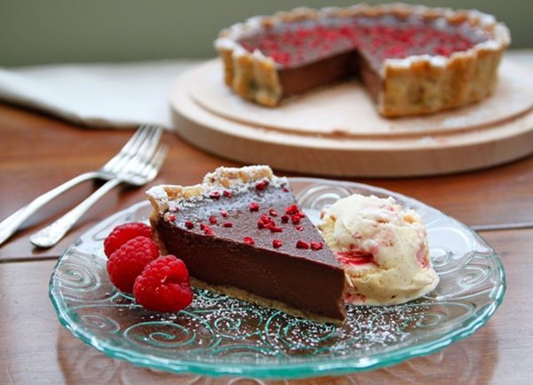 Dark chocolate and hazelnut tart with raspberry, pink peppercorn and crushed meringue ice cream 
