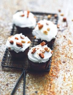 Dark chocolate muffins with cream cheese icing and caramelised peanuts