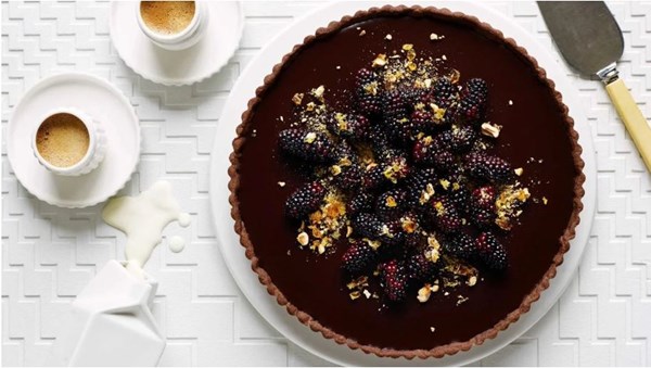 Dark chocolate tart with blackberries and hazelnut praline