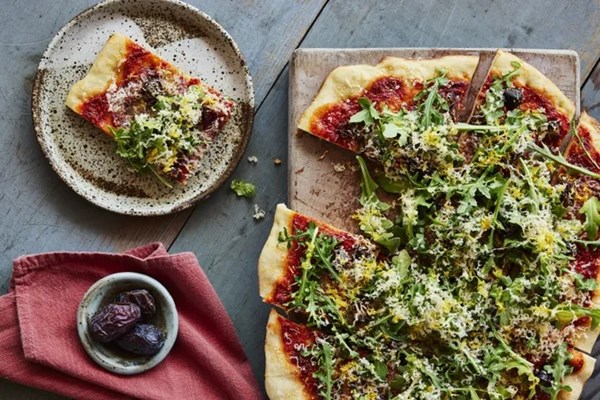 Date, sopressata, arugula, and smoked Gouda pizza