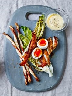 Deconstructed crispy pancetta & charred lettuce Caesar salad with anchovy straws