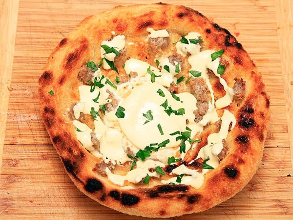 Deep fried breakfast pizza with sausage, eggs, Parmesan, and Hollandaise