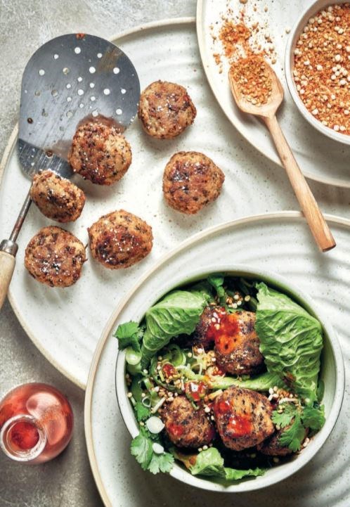 Deep-fried mushroom balls in salad leaves with smoky chilli sauce