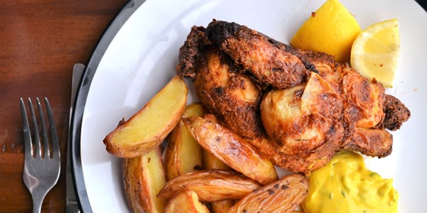 Deep-fried poussin with tarragon mayonnaise and potato wedges