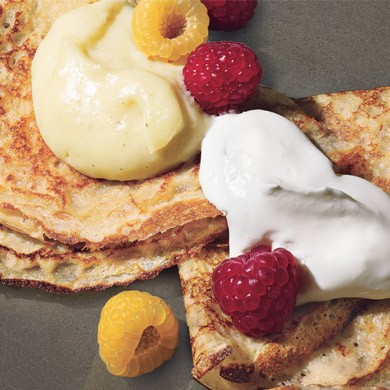 Dessert pancakes with custard and berries