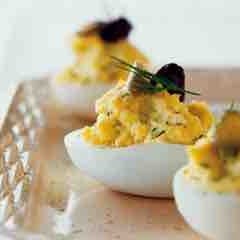 Deviled eggs on sliced heirloom tomatoes