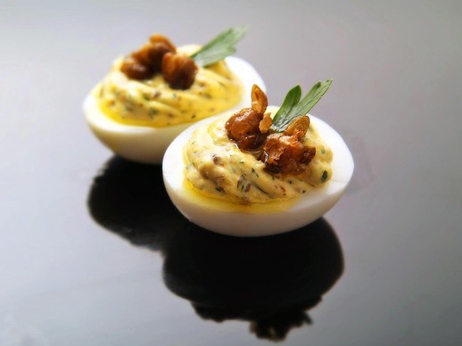 Deviled eggs with fried capers, lemon, and parsley