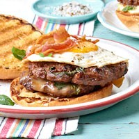 Double cheeseburgers with basil, bacon, and egg