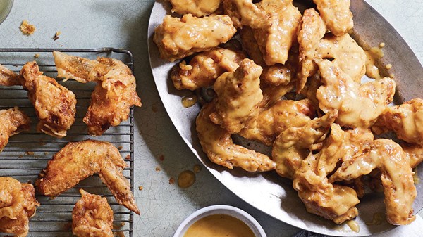 Double-fried chicken wings with miso-mustard Old Bay sauce