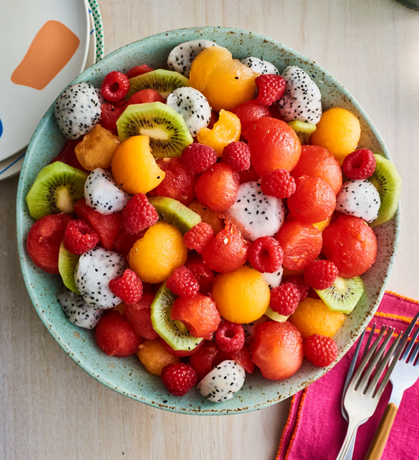 Dragon fruit salad with melons, raspberries, and kiwi