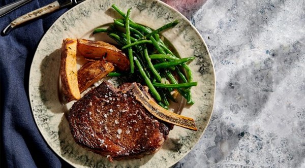 Dry-aged rib steak with fried potato wedges and string beans [Brad Mahlof]
