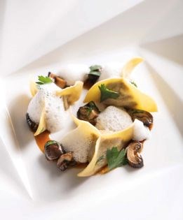 Duck and foie gras ravioli in mushroom fumet with shiitake caps and chervil