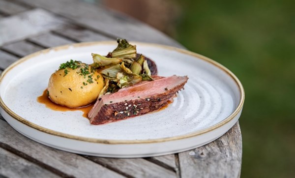Duck with sauerkraut potato dumplings and hispi cabbage