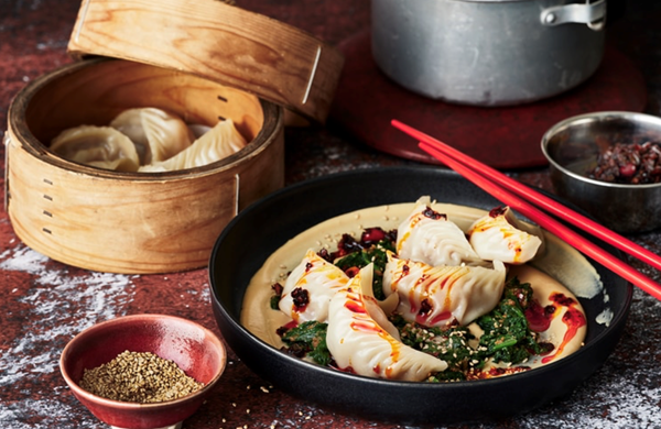 Dumplings with sesame chilli sauce and spinach