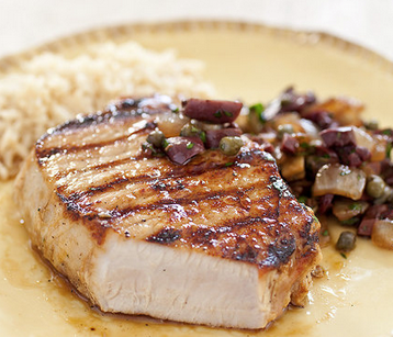 Easy grilled boneless pork chops with onion, olive, and caper relish