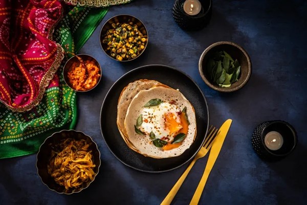 Egg hoppers with garlic and red pepper chutney, onion relish and corn relish
